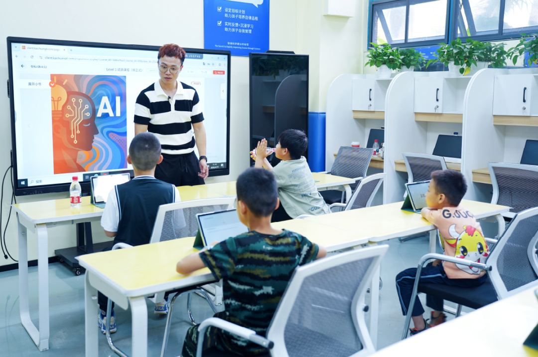 学员在配备电脑的教室里跟随导师完成 AI 课程任务